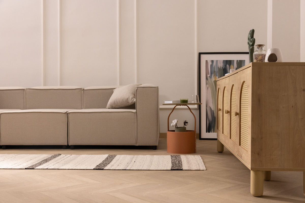 Handwoven black and white wool-blend flatweave rug with striped pattern in a modern living room setting.