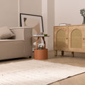 Minimalist white wool and cotton flatweave rug in a modern living room with neutral decor and herringbone flooring.