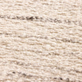 Close-up of a white handwoven wool and cotton flatweave rug with subtle grey horizontal striped texture.