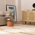 Handwoven white and brown wool-blend flatweave rug with a textured striped pattern in a modern living room setting.