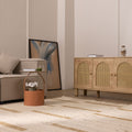 Beige and brown handwoven wool-blend flatweave rug with a textured striped pattern in a modern living room setting.