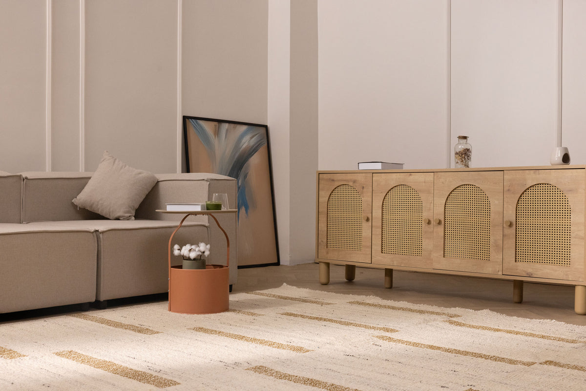 Beige and brown handwoven wool-blend flatweave rug with a textured striped pattern in a modern living room setting.