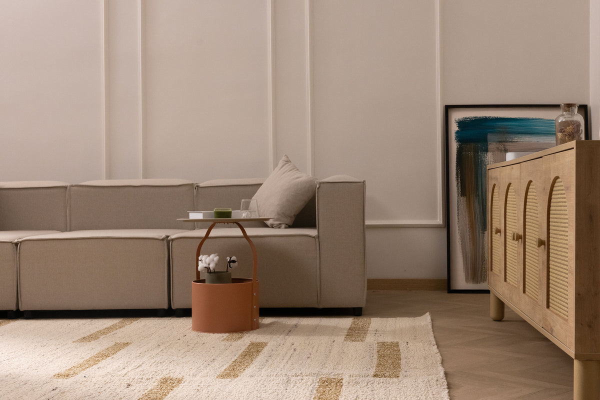 Beige and brown handwoven wool-blend flatweave rug with a geometric pattern in a modern living room setting.