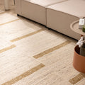 Handwoven beige and brown wool-blend flatweave rug with a modern geometric pattern in a contemporary living room.