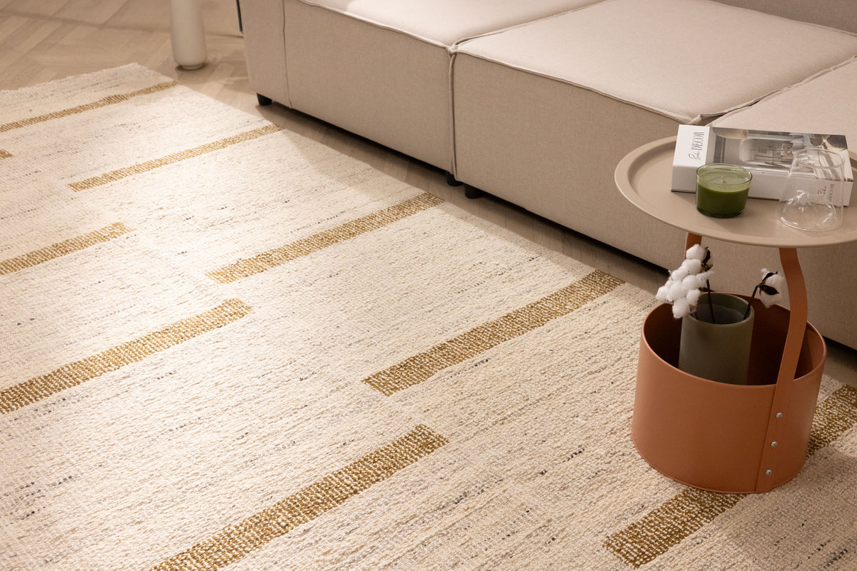 Handwoven beige and brown wool-blend flatweave rug with a modern geometric pattern in a contemporary living room.