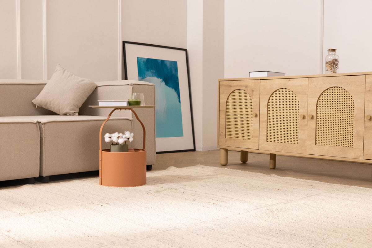 Minimalist white wool and cotton flatweave rug in a modern living room with neutral furniture and decor.