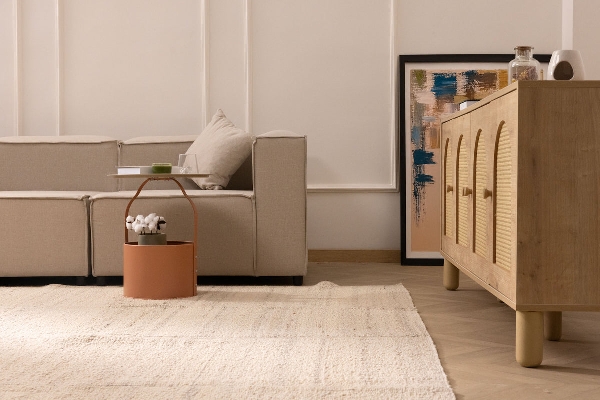 Minimalist white handwoven wool and cotton flatweave rug in a modern living room setting.