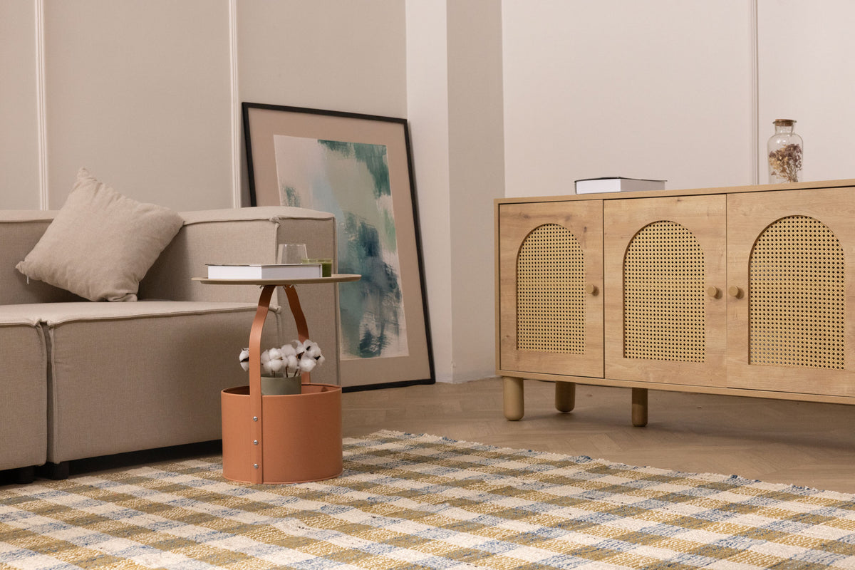 Handwoven white, brown, and blue checkered wool-blend flatweave rug in a modern living room setting.