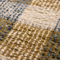 Close-up of a handwoven white, brown, and blue checkered flatweave rug made from a durable wool and cotton blend.