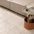 Luxurious off-white shaggy wool rug with a thick, textured pile placed in a cozy modern living room.