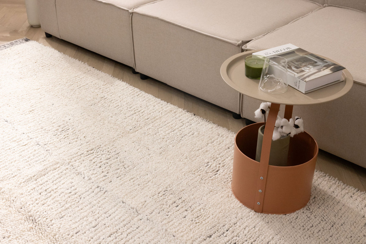 Luxurious off-white shaggy wool rug with a thick, textured pile placed in a cozy modern living room.