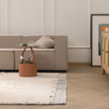 Handwoven sky blue and cream shaggy wool rug with a high-pile texture in a cozy, modern living room setting.