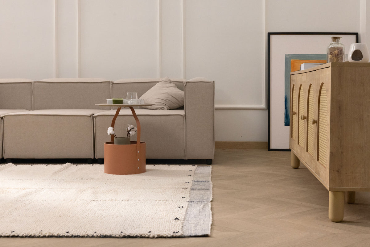 Handwoven sky blue and cream shaggy wool rug with a high-pile texture in a cozy, modern living room setting.