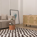 Handwoven black and white checkered shaggy wool rug with a thick, soft pile in a modern living room setting.
