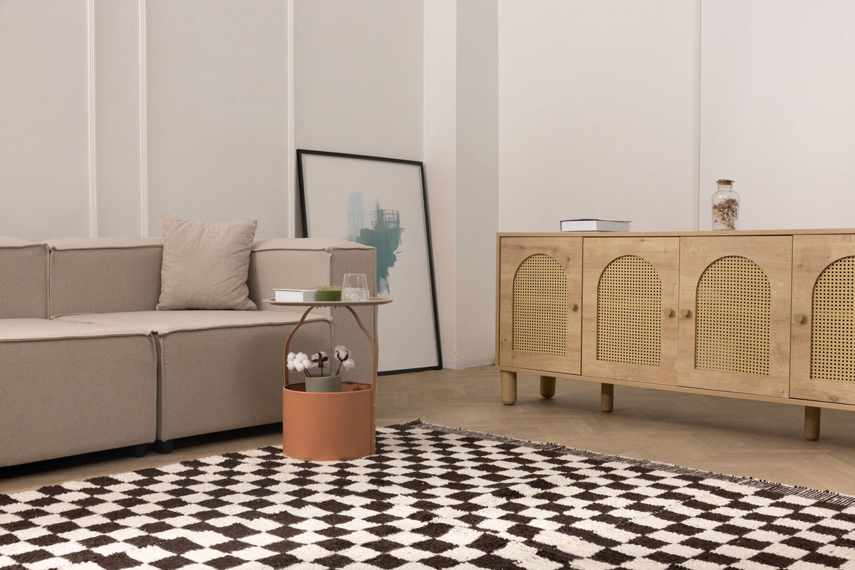 Handwoven black and white checkered shaggy wool rug with a thick, soft pile in a modern living room setting.