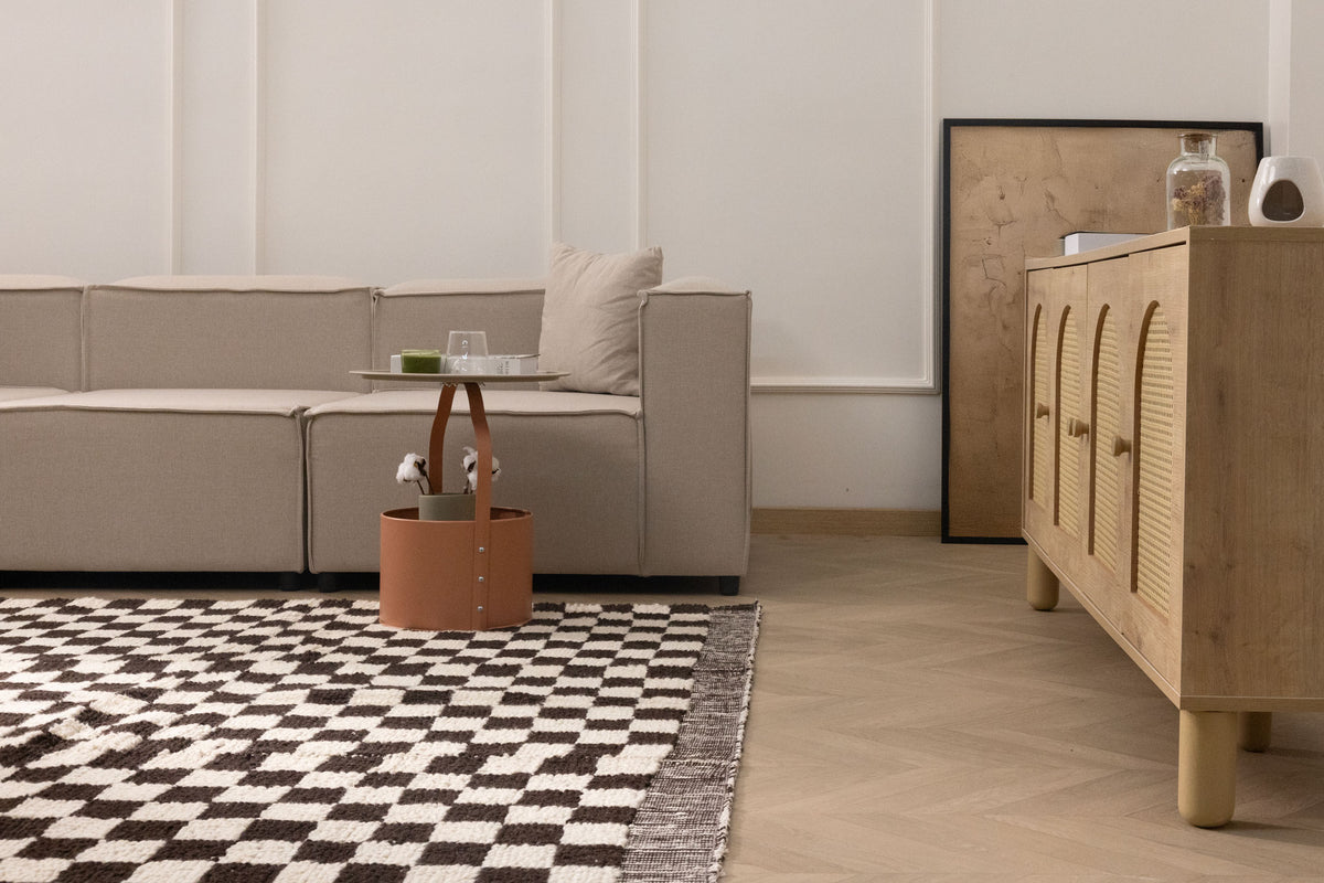 Handwoven black and white checkered shaggy wool rug with a thick, soft pile in a modern living room setting.