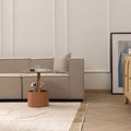 Handwoven army shaggy wool rug with a thick, textured cream pile and decorative border in a cozy, modern living room.
