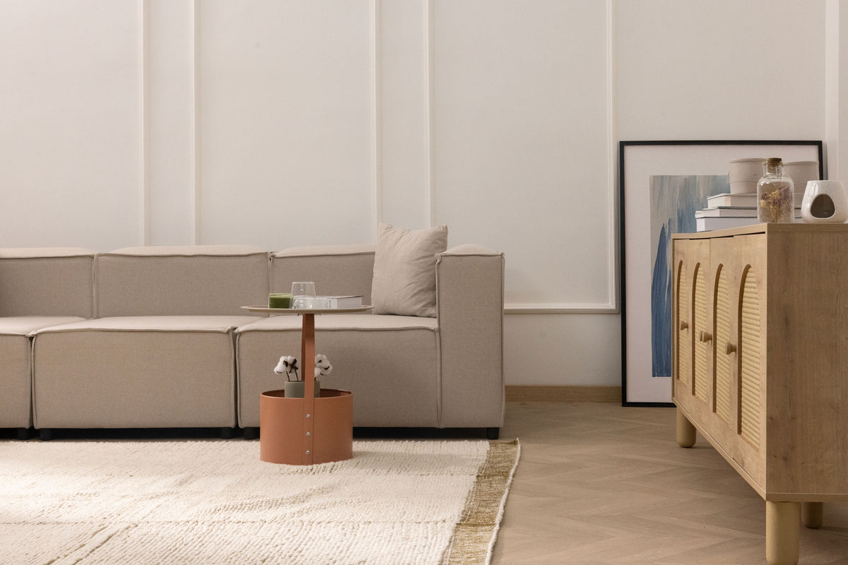 Handwoven army shaggy wool rug with a thick, textured cream pile and decorative border in a cozy, modern living room.