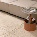 Handwoven dark mustard shaggy wool rug with a thick, textured pile placed in a cozy living room setting.
