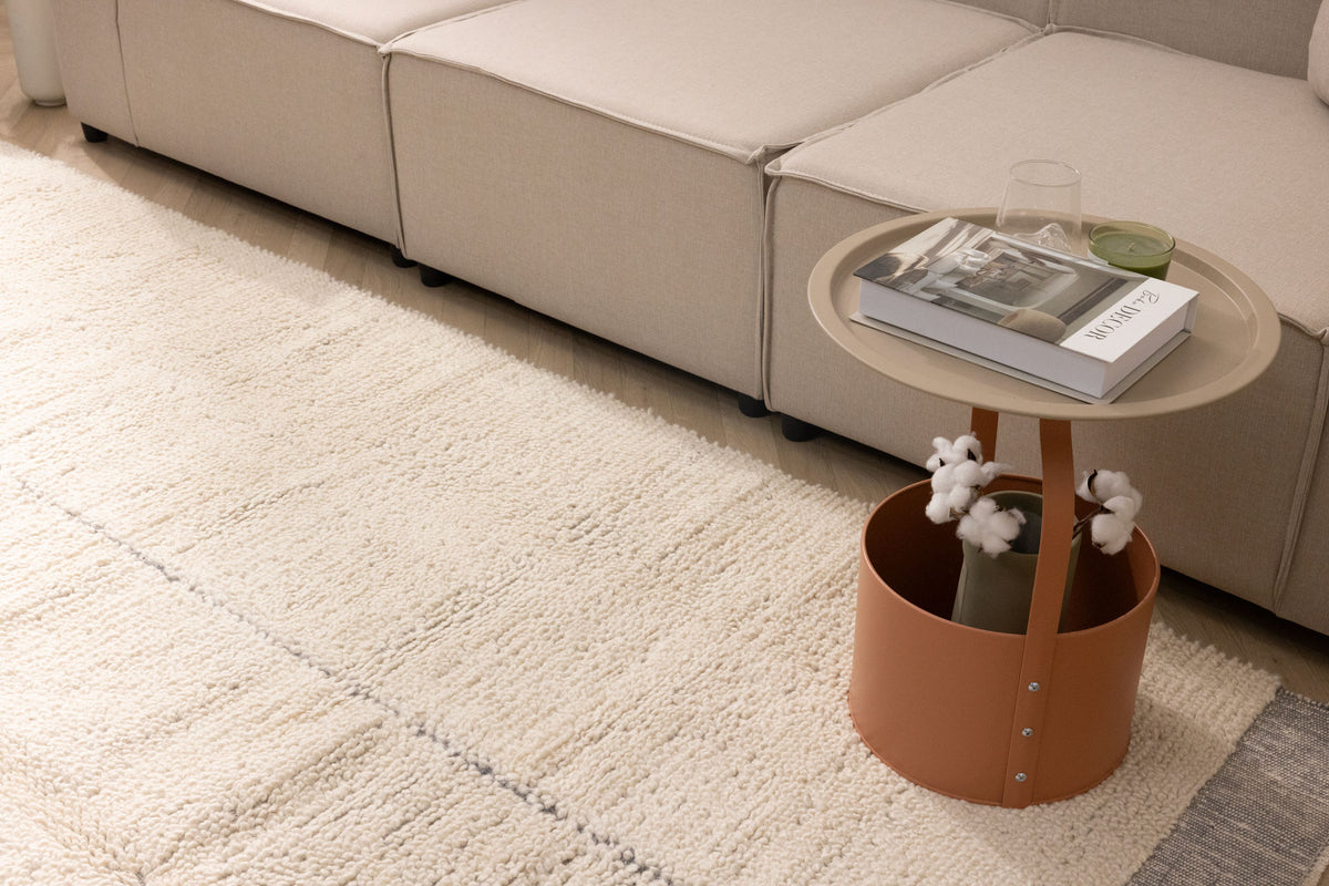 Silver gray shaggy wool rug with a thick, handwoven high-pile texture placed in a cozy, modern living room setting.