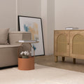 Handwoven white shaggy wool area rug with a thick, soft pile texture in a cozy, modern living room setting.