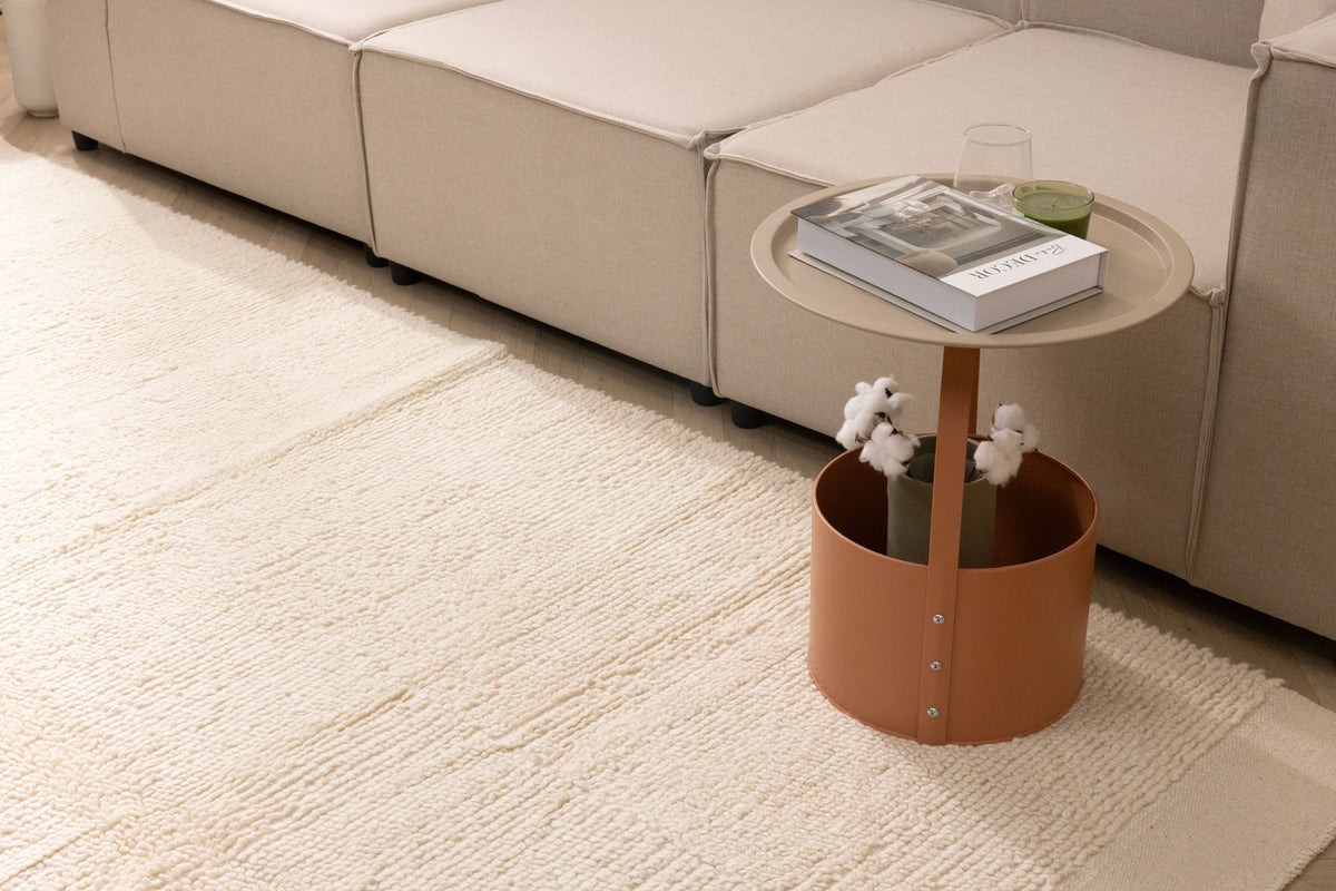 Handwoven white shaggy wool area rug with a thick, textured pile placed in a cozy modern living room.