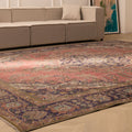 Oversized pink Persian-style wool and cotton area rug with intricate floral patterns in a modern living room setting.