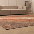 Oversized red Persian-style wool and cotton area rug with intricate floral patterns in a modern living room.