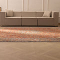 Oversized red Persian-style wool and cotton rug with intricate floral motifs in a modern living room.