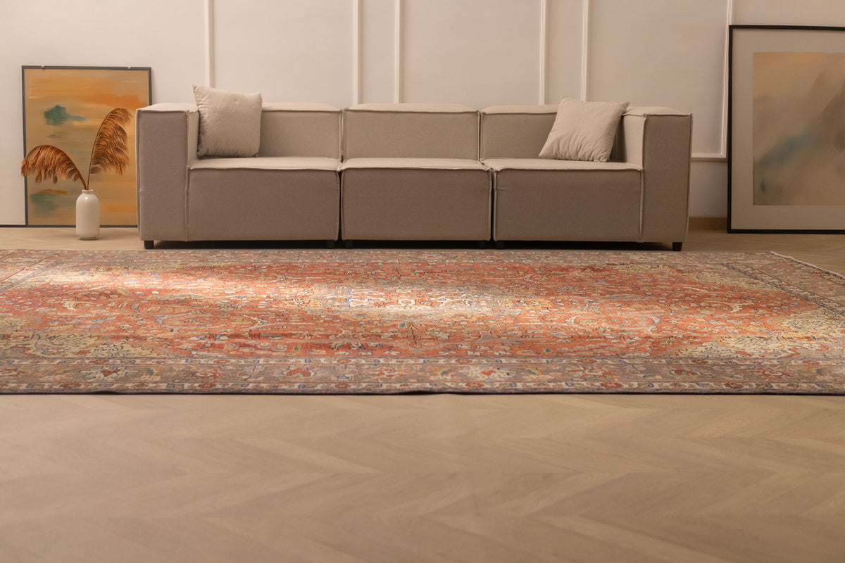 Oversized red Persian-style wool and cotton rug with intricate floral motifs in a modern living room.