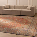 Oversized red Persian-style wool and cotton area rug with intricate floral patterns in a modern living room.