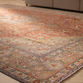 Oversized red Persian-style area rug with intricate floral patterns, crafted from a wool and cotton blend.