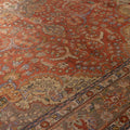 Handmade red Persian-style wool and cotton area rug featuring intricate floral motifs and traditional maximalist patterns.
