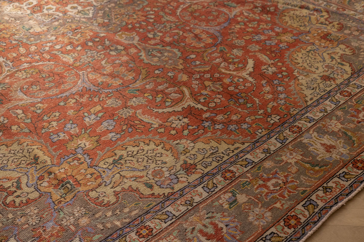 Handmade red Persian-style wool and cotton area rug featuring intricate floral motifs and traditional maximalist patterns.