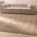 Oversized wool and cotton Persian-style area rug featuring brown and green floral patterns in a maximalist farmhouse design.