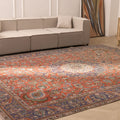 Oversized 9.7x13 ft Persian-style wool and cotton rug with red and navy floral patterns in a bohemian living room.