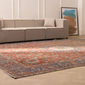 Oversized 9.7x13 ft Persian-style wool and cotton area rug featuring red and navy floral patterns in a living room.