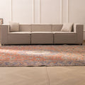 Oversized red and navy Persian-style wool and cotton area rug with intricate floral patterns in a modern living room.