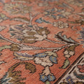 Handmade wool and cotton Persian-style rug featuring a red and navy floral maximalist pattern.