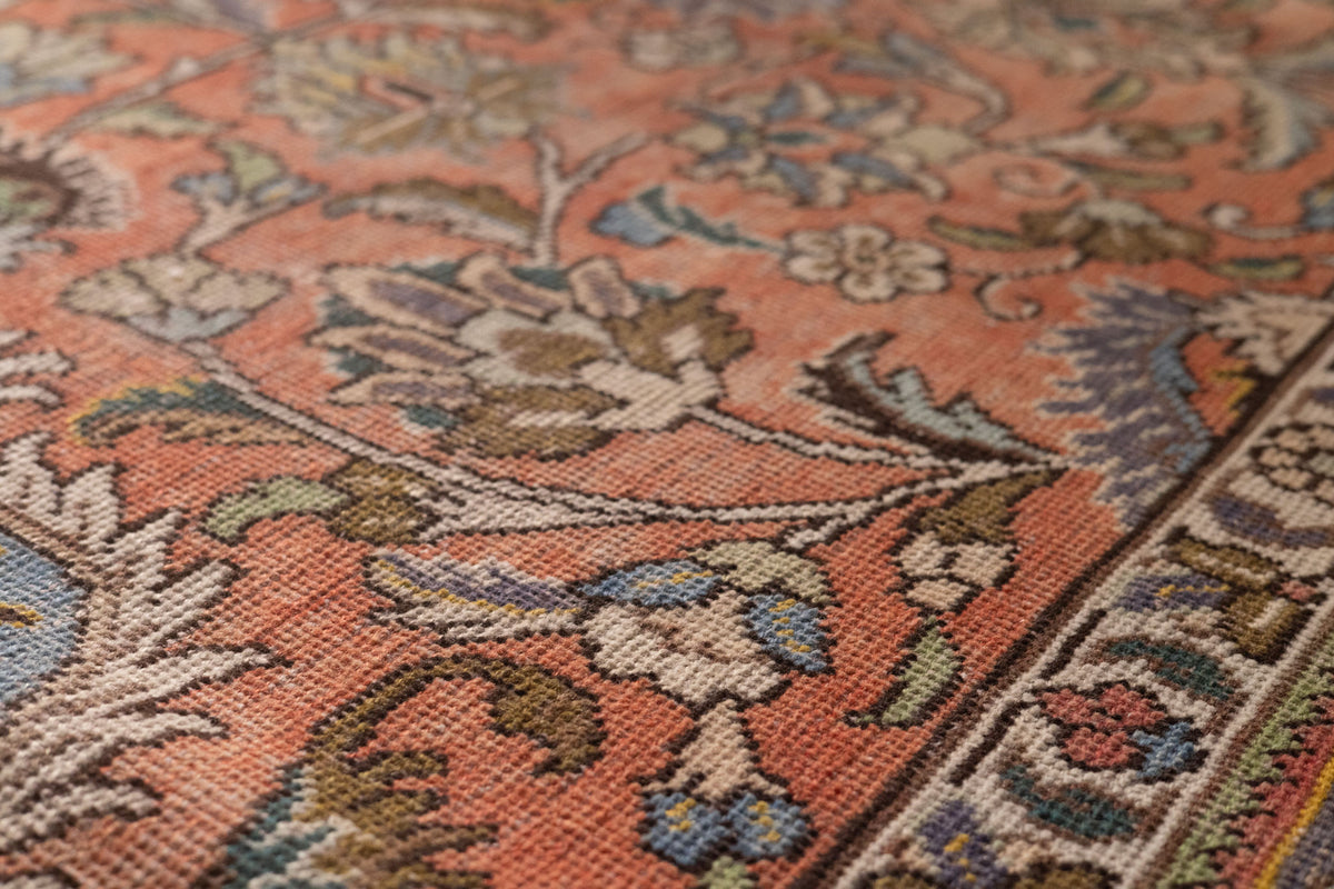 Handmade wool and cotton Persian-style rug featuring a red and navy floral maximalist pattern.