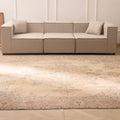 Oversized beige Persian-style wool and cotton area rug with intricate floral motifs in a traditional bohemian living room.