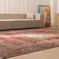Oversized red Persian-style wool and cotton rug with intricate floral patterns in a bright, modern living room.