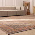 Oversized brown Persian-style wool and cotton area rug with intricate floral patterns in a traditional living room.