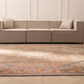 Oversized brown Persian-style wool and cotton area rug with intricate floral patterns in a modern living room.