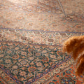 Oversized brown Persian-style wool and cotton rug with intricate floral motifs and traditional maximalist patterns.