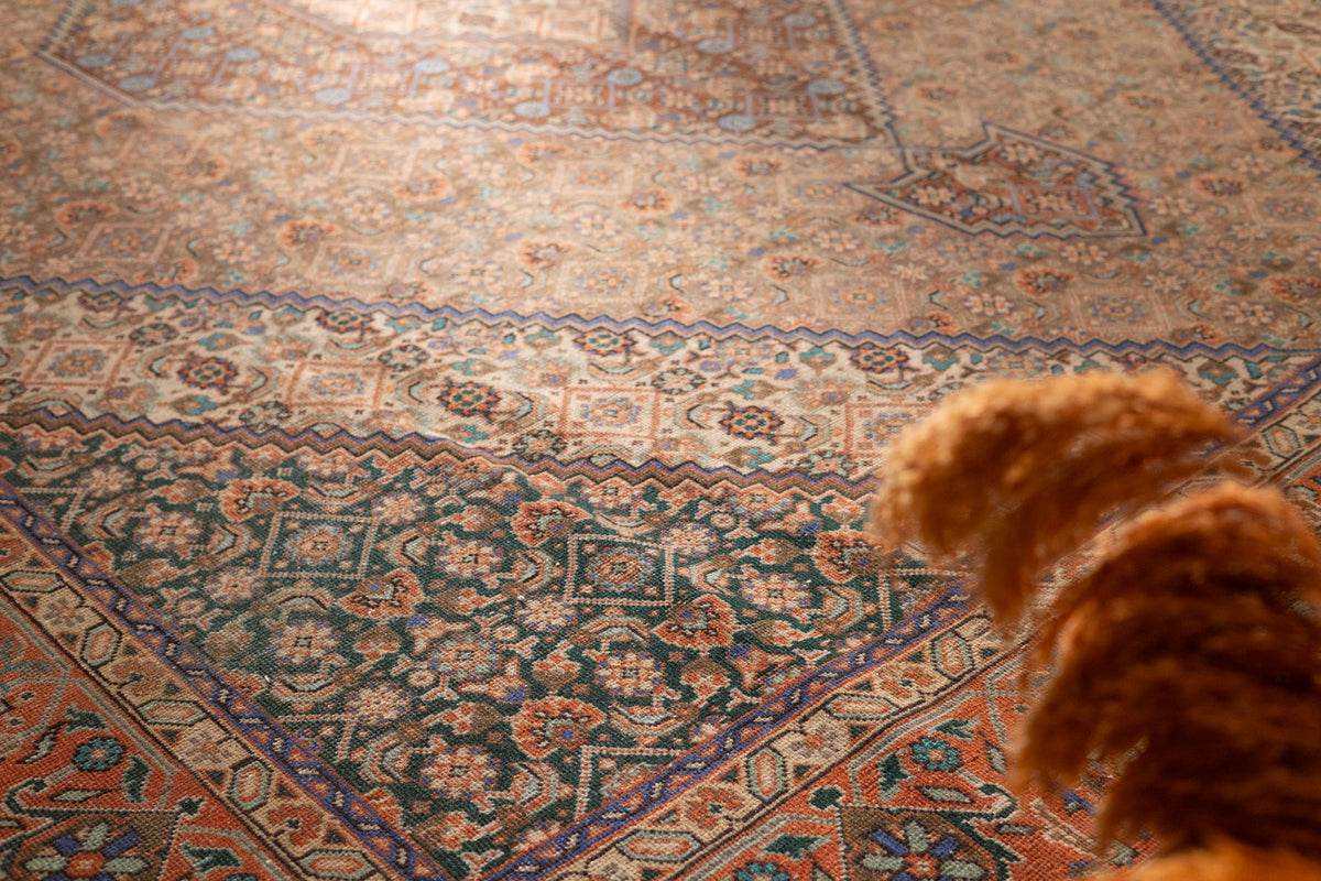Oversized brown Persian-style wool and cotton rug with intricate floral motifs and traditional maximalist patterns.