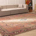 Oversized 9x12 wool and cotton Persian-style rug featuring brown floral patterns in a traditional farmhouse living room.