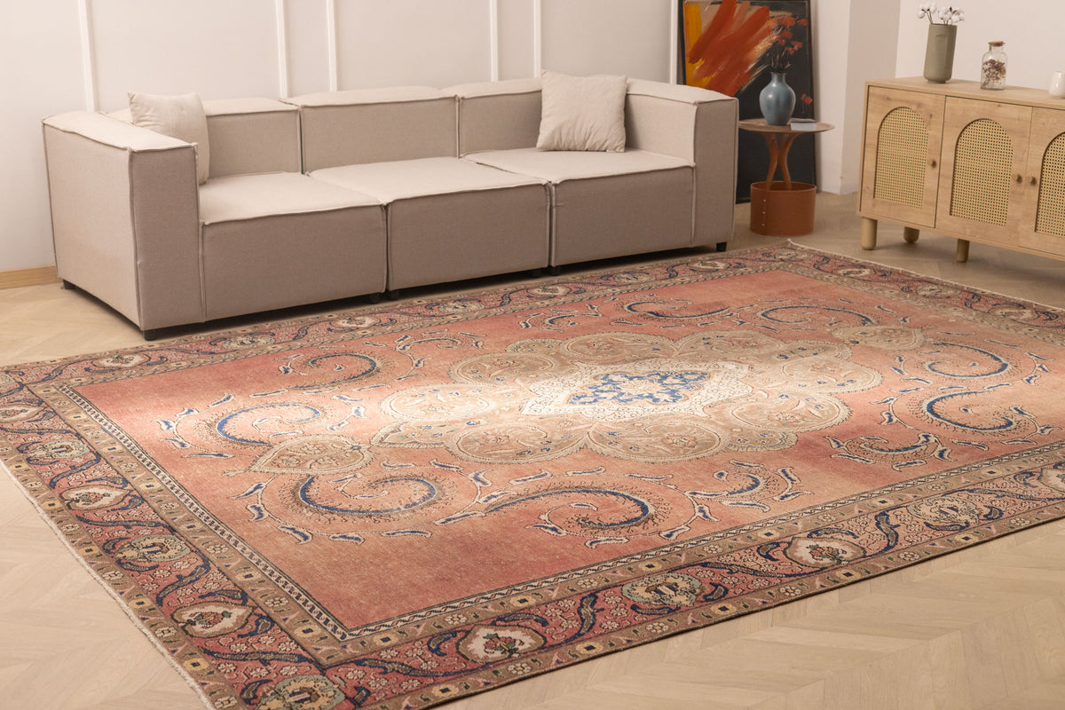 Oversized 9x12 wool and cotton Persian-style rug featuring brown floral patterns in a traditional farmhouse living room.