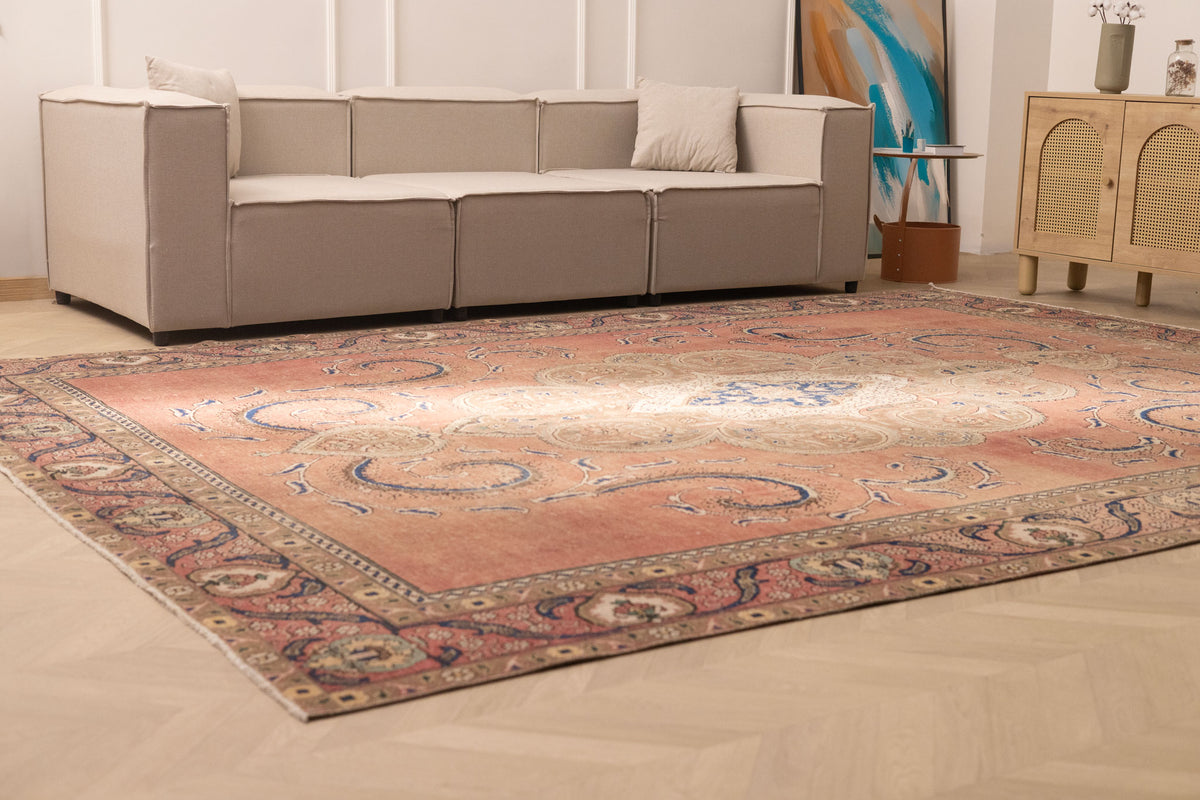 Oversized 9x12 Persian-style wool and cotton rug featuring traditional brown floral patterns in a living room setting.
