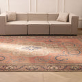Oversized 9x12 Persian-style wool and cotton rug with brown floral patterns in a traditional farmhouse living room.